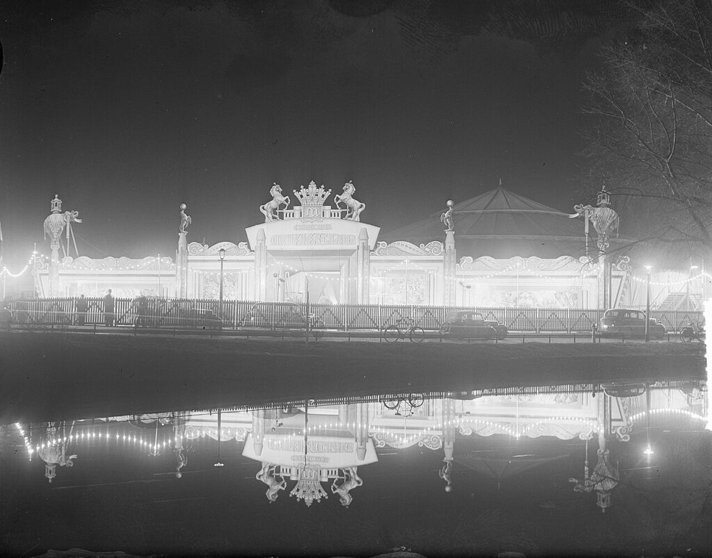 The exterior of a glowing circus tent.