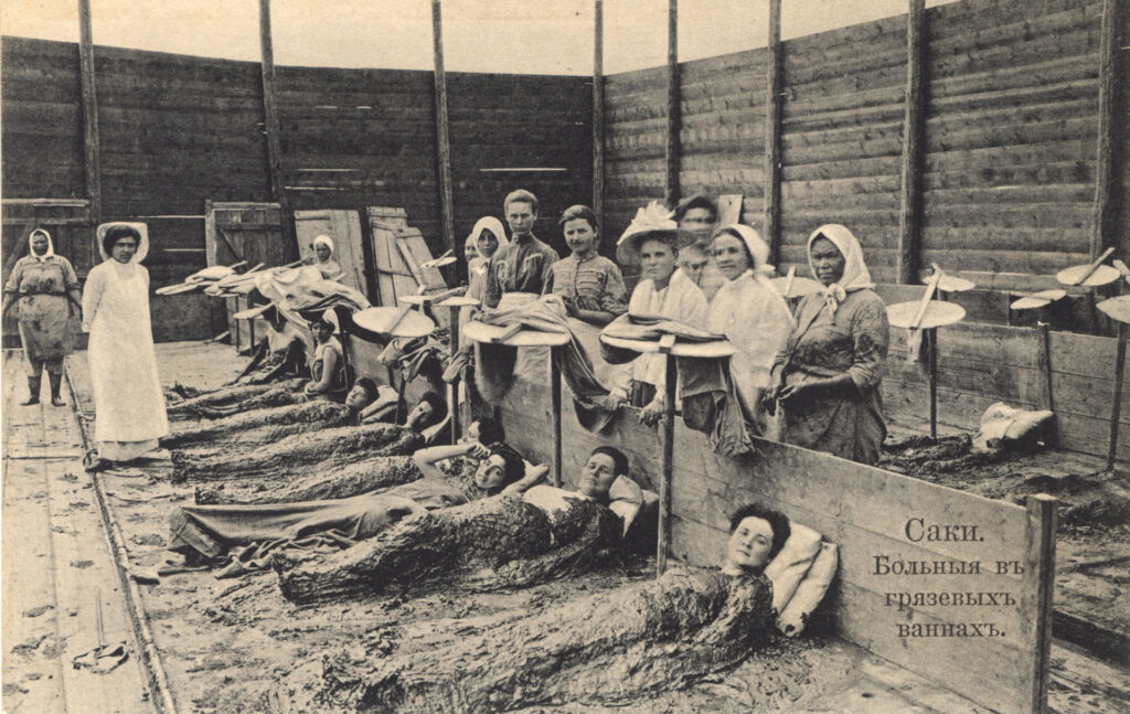 Woman laying on the ground in mud.