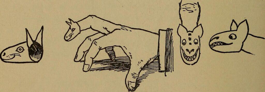A hand displaying a fingertip puppet. 