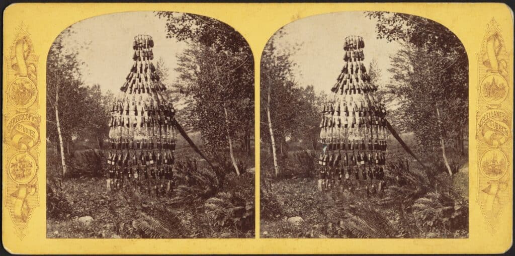 A stereograph featuring a giant bottle-shaped collection of bottles. 