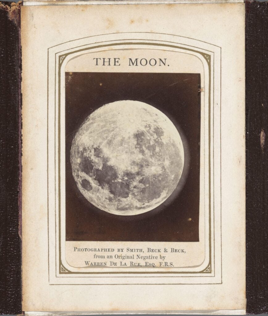 A photograph of an almost full moon.